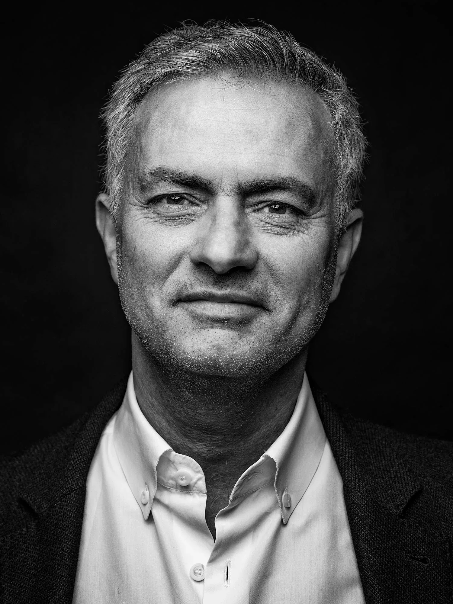 A black and white portrait of José Mourinho by Tom Oldham